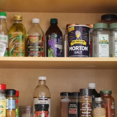 Photo of a pantry filled with staple items like spices, vinegars, oils, and salt