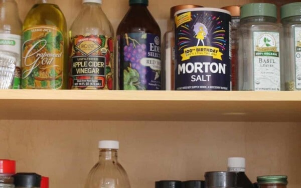 Photo of a pantry filled with staple items like spices, vinegars, oils, and salt