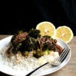 Lemon Ginger Beef and Broccoli served over white rice on a white plate