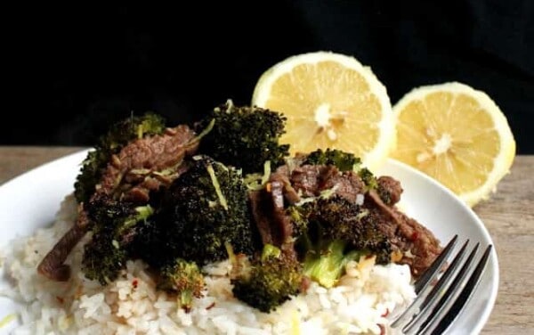 Lemon Ginger Beef and Broccoli served over white rice on a white plate