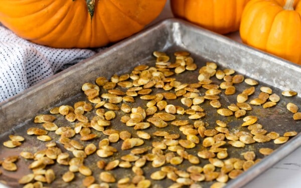 Roasted Pumpkin Seeds on a cooking sheet.