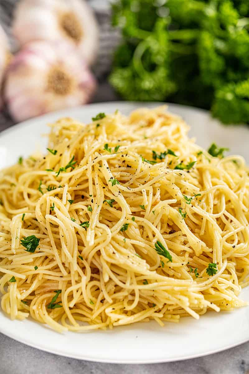 A large plate full of brown butter garlic angel hair pasta
