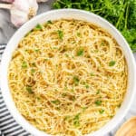 An overhead view of a large bowl filled with angel hair pasta