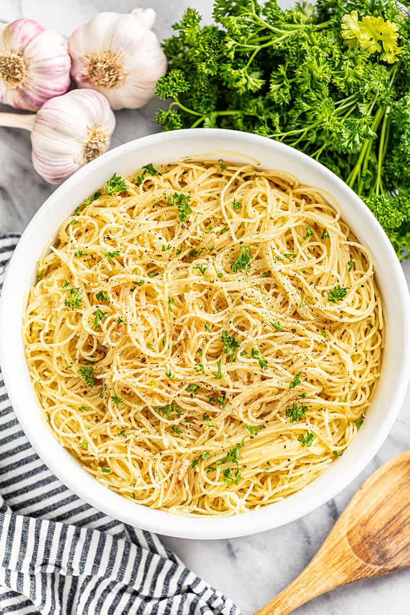 An overhead view of a large bowl filled with angel hair pasta