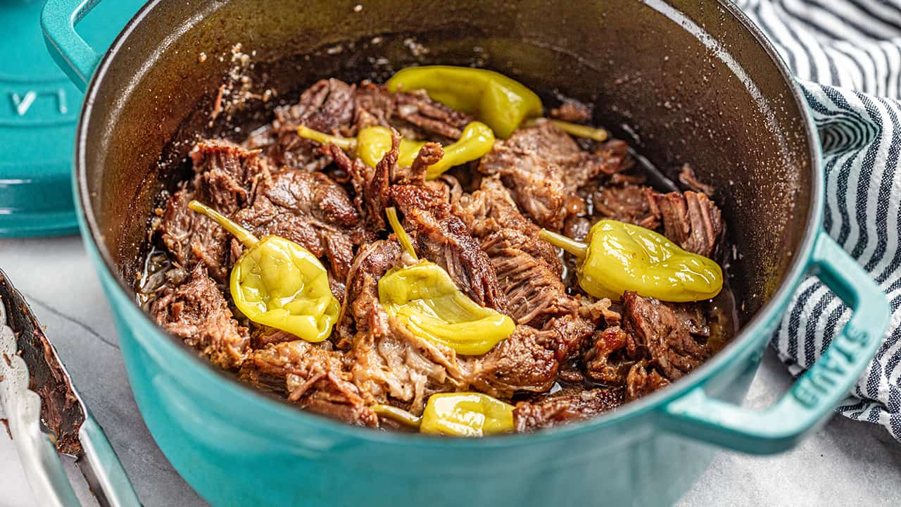 Mississippi pot roast with pepperoncinis in a teal dutch oven