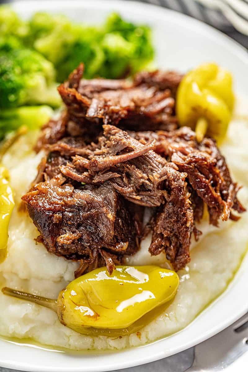 Mississippi pot roast with mashed potatoes on a white plate