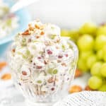 Creamy grape salad overfilled in a small glass serving dish