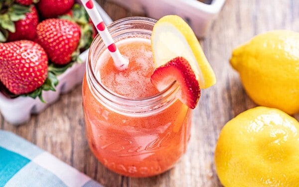 strawberry kiwi lemonade with a lemon and strawberry slice on the rim