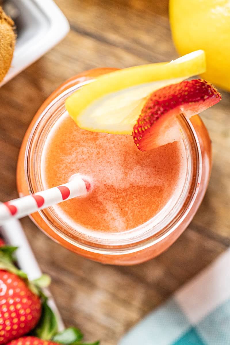 Overhead view into a glass jar of strawberry kiwi lemonade