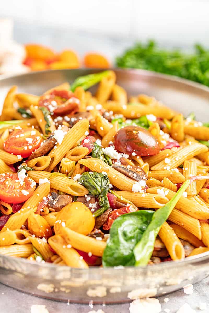 Penne pasta and vegetables in a skillet