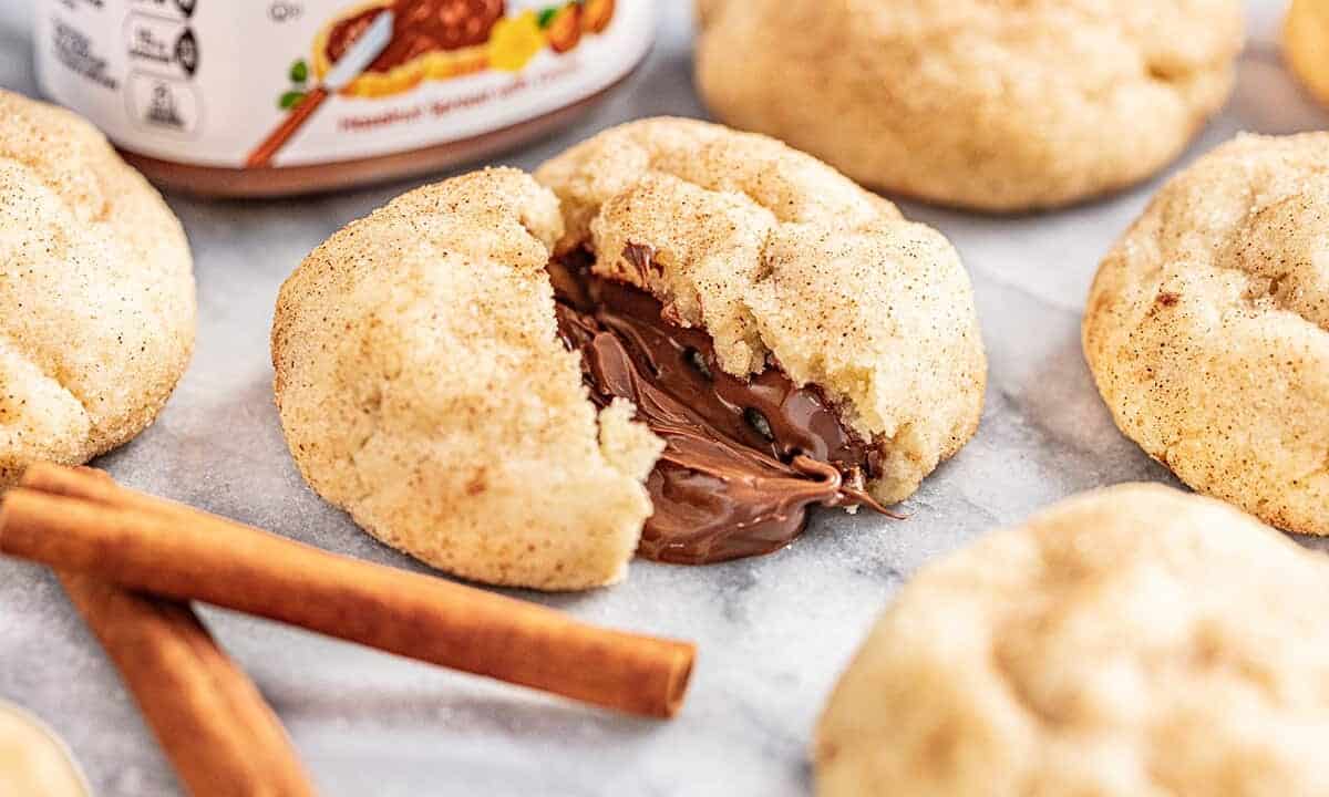 Churro cookie broken in half with chocolate melting out from the middle