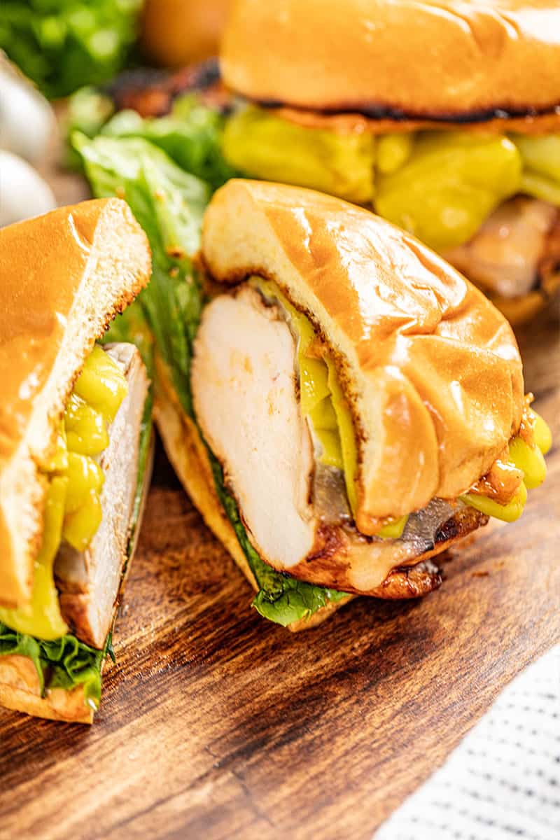 a sante fe grilled chicken sandwich cut in half to show the cut chicken breast inside