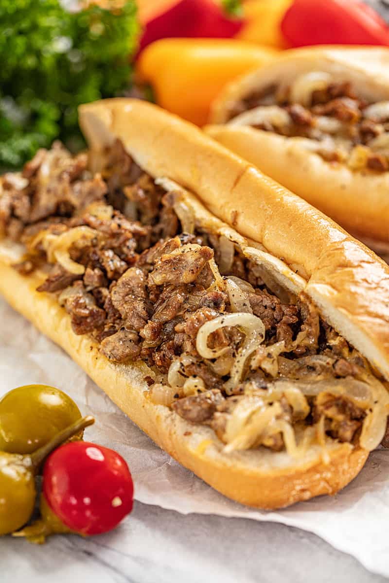 a Philly cheesesteak open to expose the meat and cheese and onions