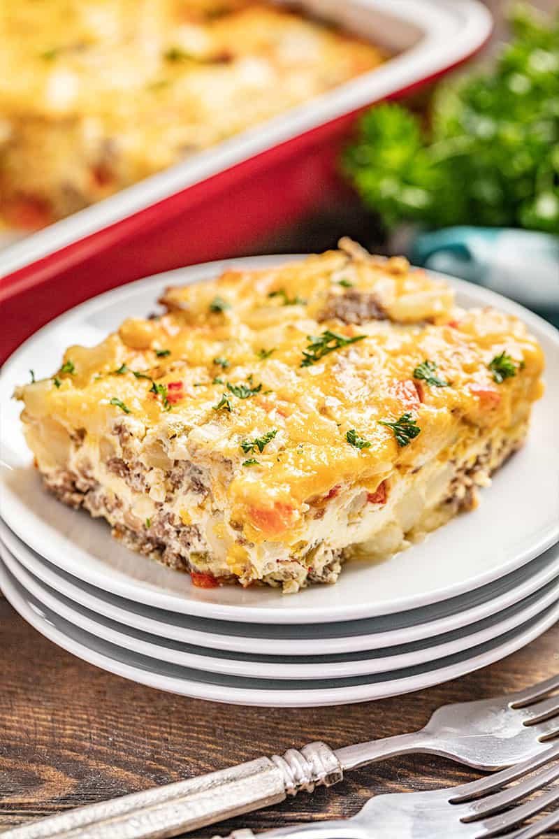 a piece of breakfast hashbrown casserole on a stack of plates.