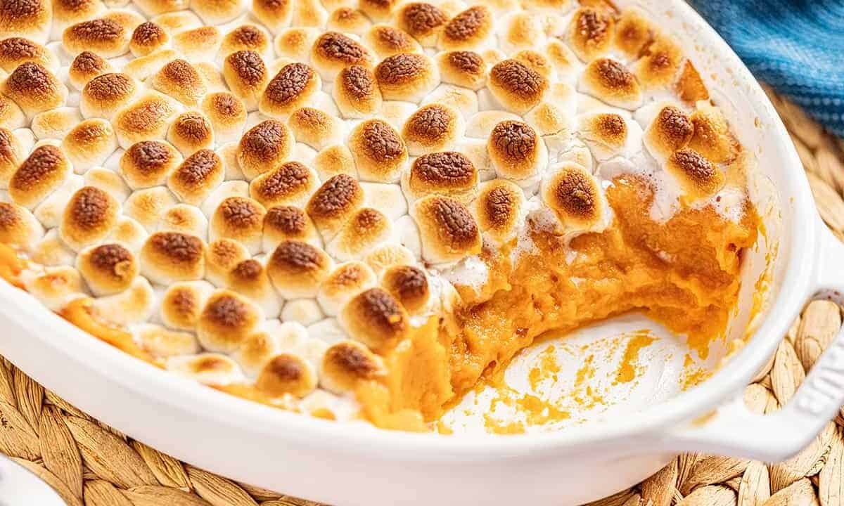Sweet potato casserole in a baking dish with a spoonful removed.