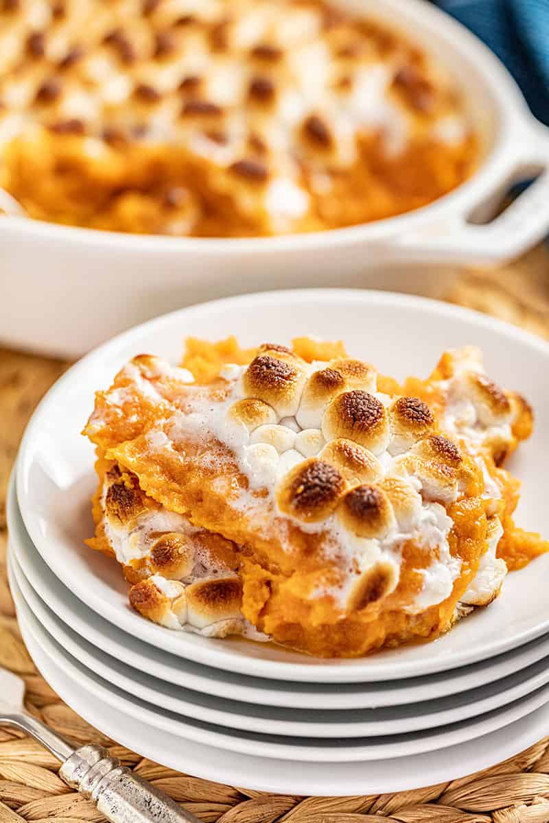 sweet potato casserole slice on a stack of plates.