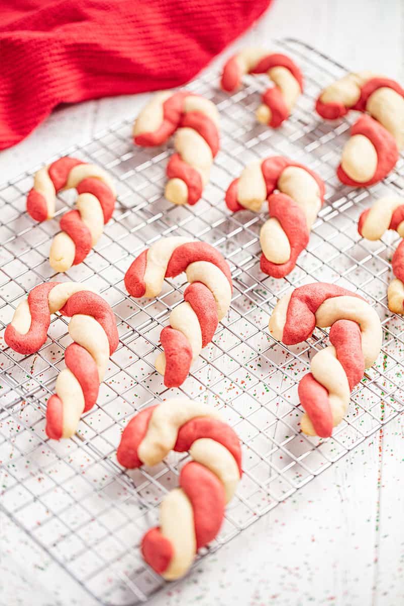 a bunch of candy cane cookie on a cooling rack.