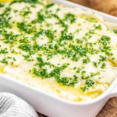 A casserole dish filled with herbed garlic mashed potatoes.