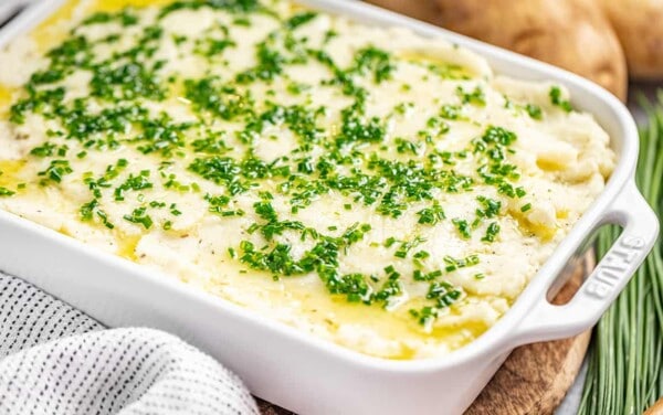 A casserole dish filled with herbed garlic mashed potatoes.