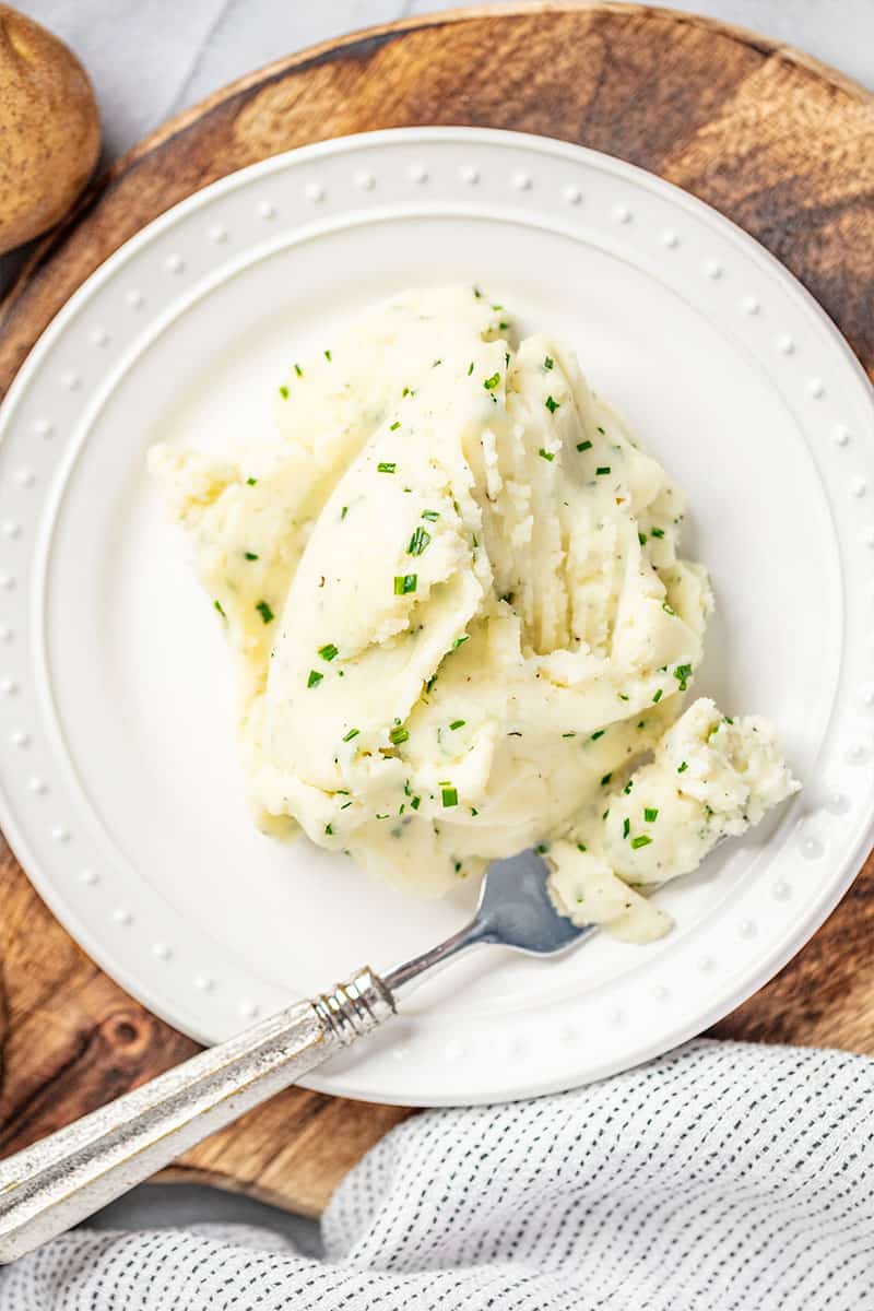 Mashed potatoes served on a white plate.
