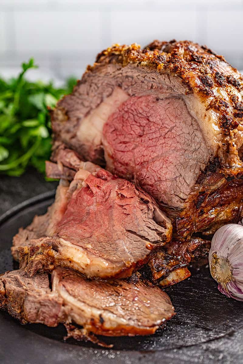 a slice of horseradish crusted prime rib cut off from the roast.