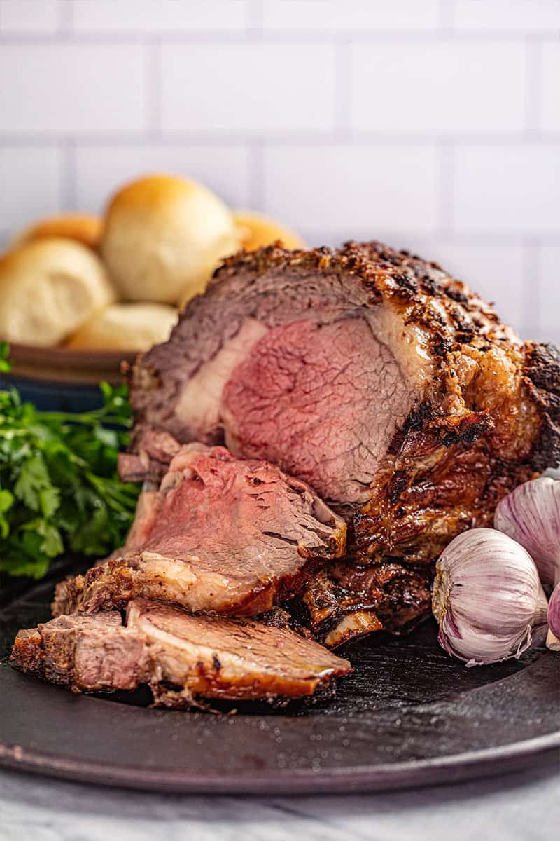 A prime rib roast crusted with horseradish and on a platter.