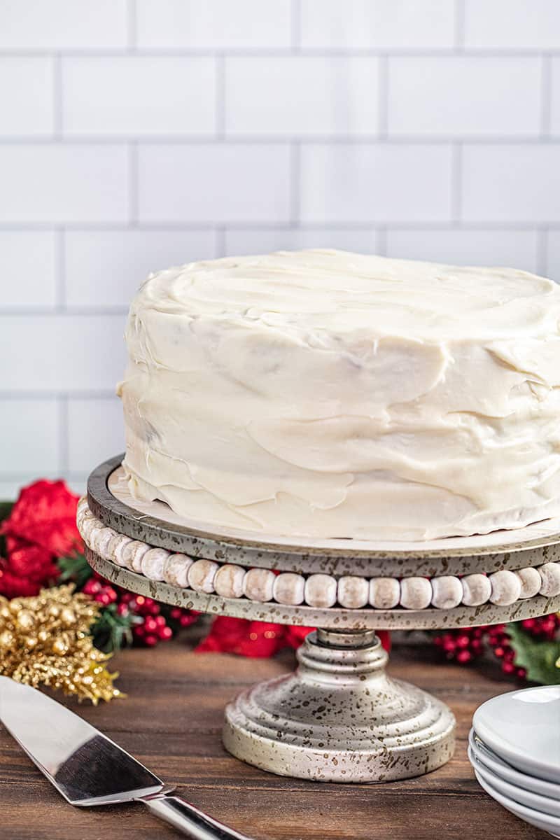 A whole Christmas gingerbread cake on a cake stand.