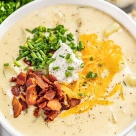 Creamy potato soup served into a white bowl.