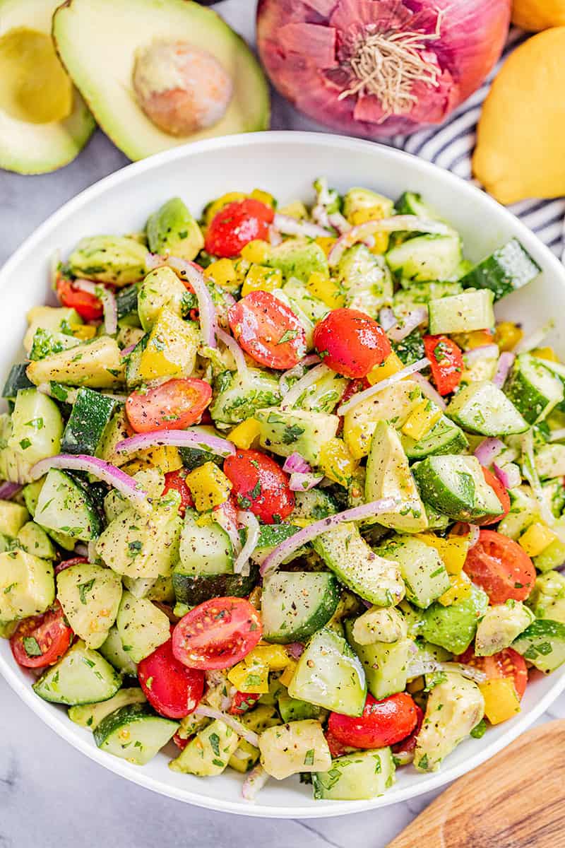 An overhead view of a bowl of tomato and avocado salad.