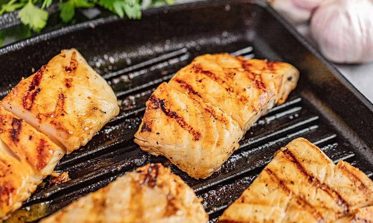 Halibut filets on a grill.