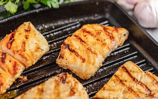 Halibut filets on a grill.