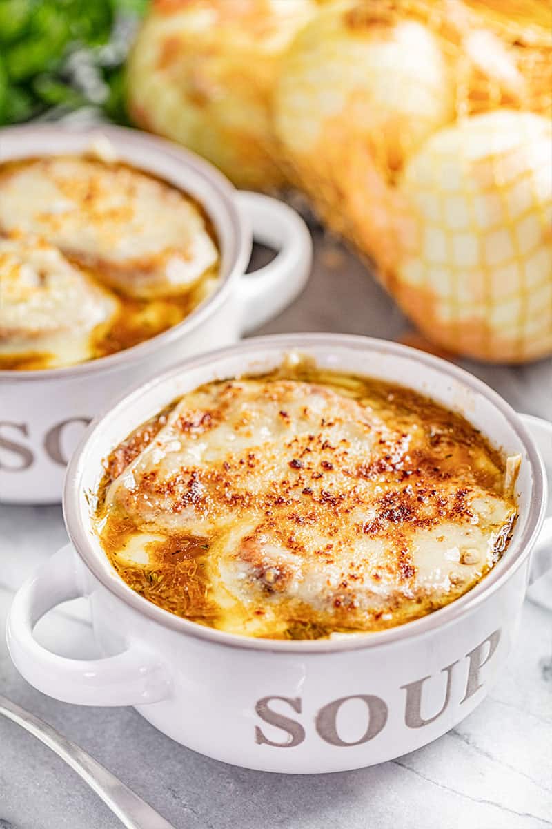 A soup bowl filled with French onion soup.