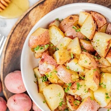 Overhead view of a bowl filled with honey roasted potatoes.