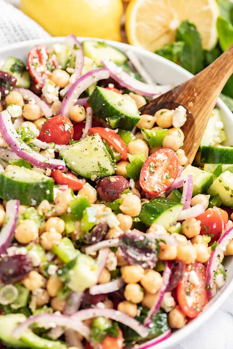 wooden spoon in a bowl of chickpea salad