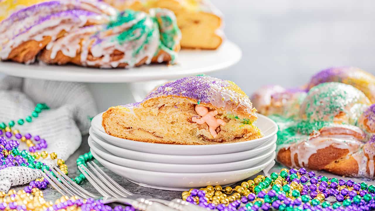 A slice of king cake with the plastic baby in the middle.