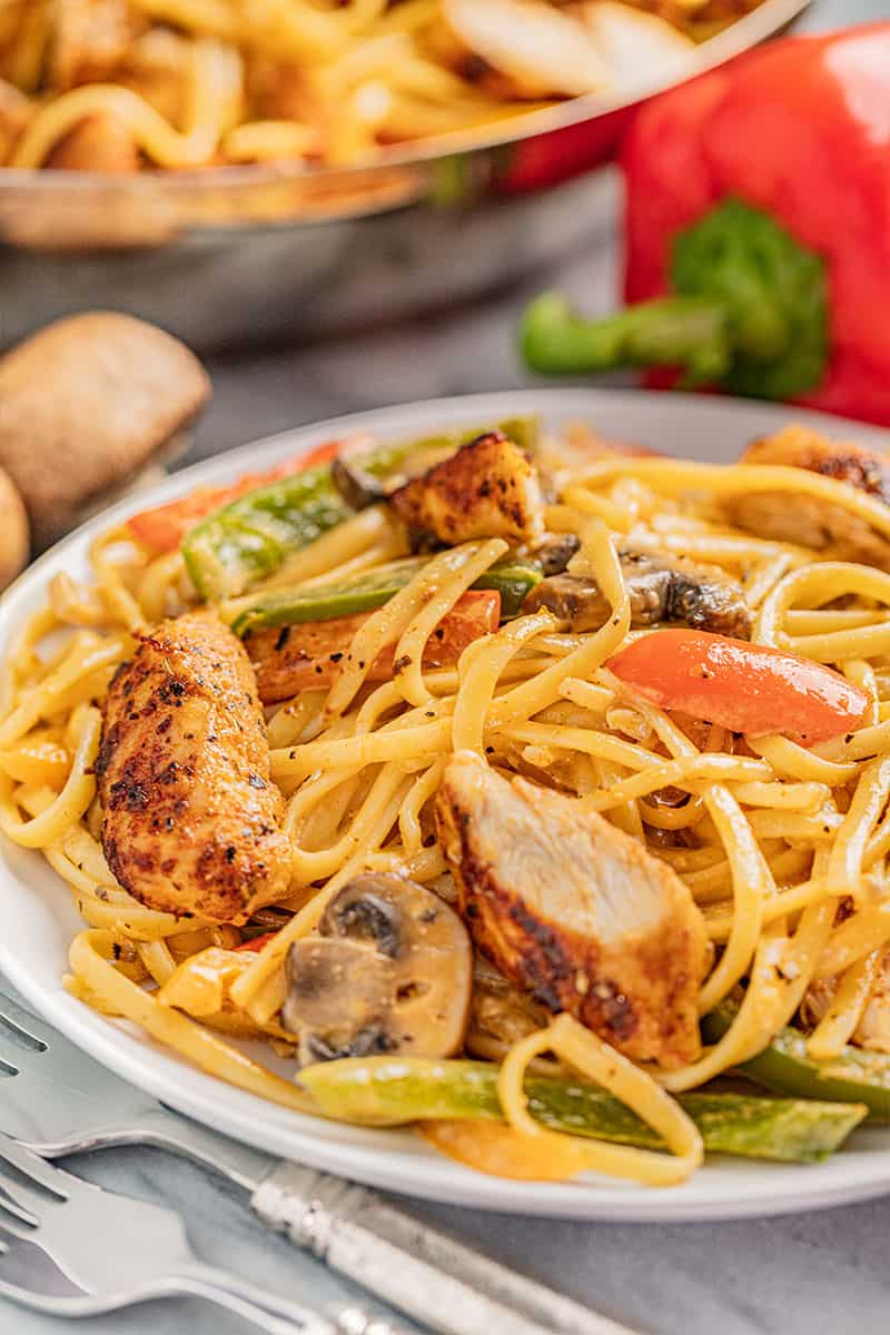 a serving plate of cajun chicken pasta.