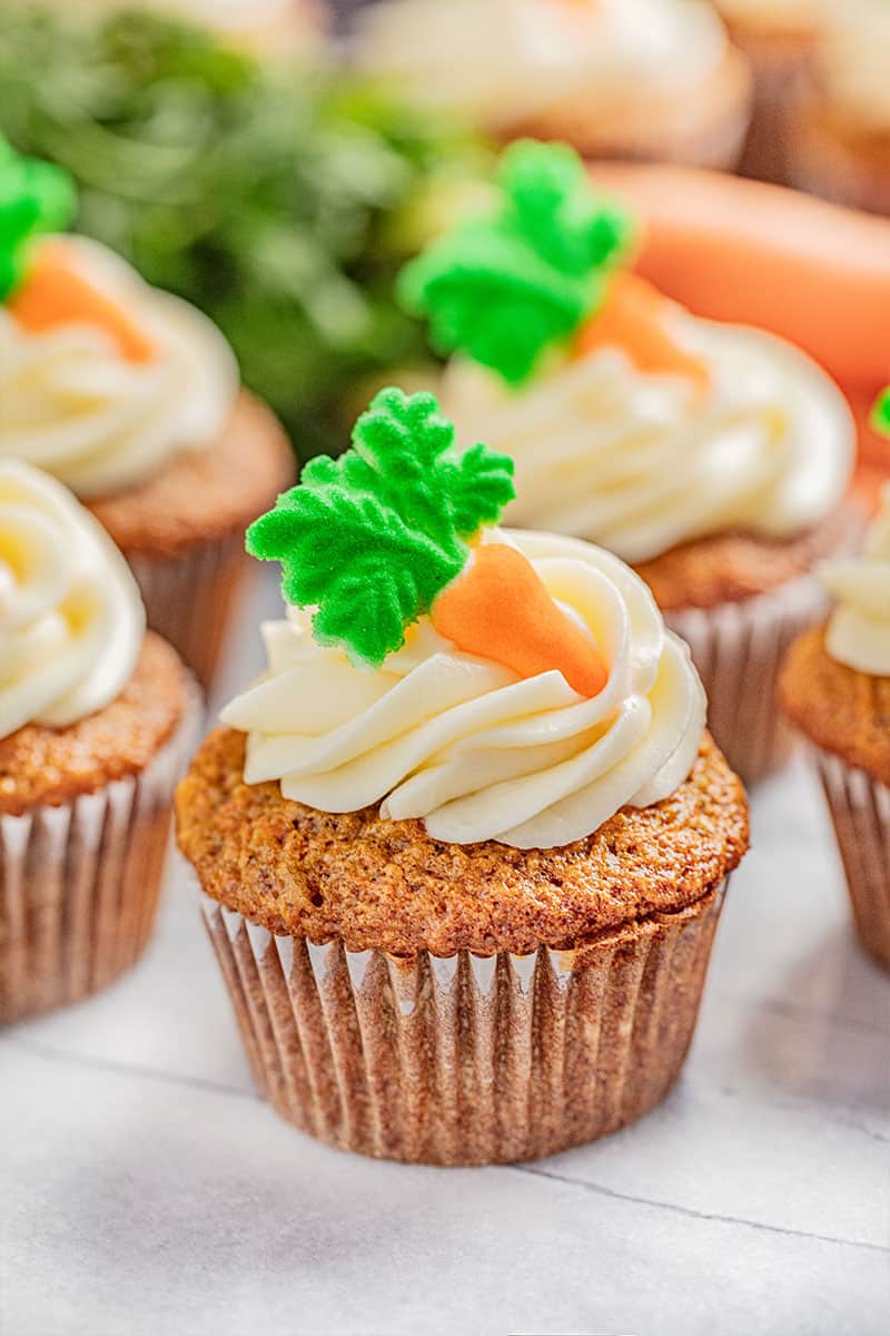 A carrot cake cupcake with cream cheese frosting.