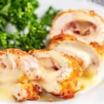 Chicken cordon bleu cut into pieces on a plate.