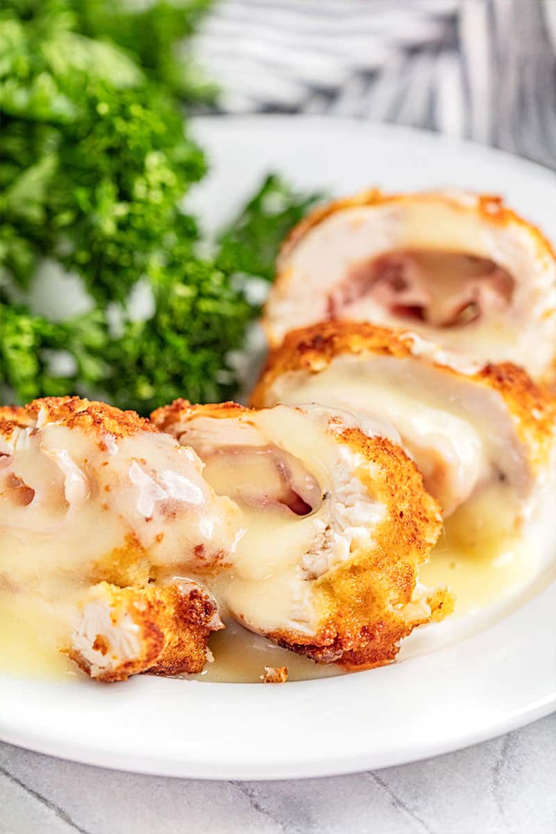 Chicken cordon bleu cut into pieces on a plate.