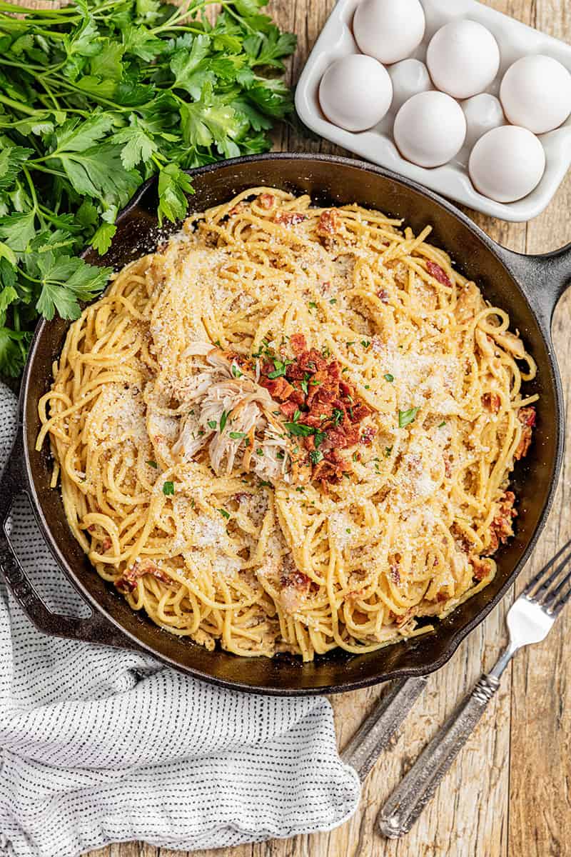 Overhead view of chicken carbonara in a skillet.
