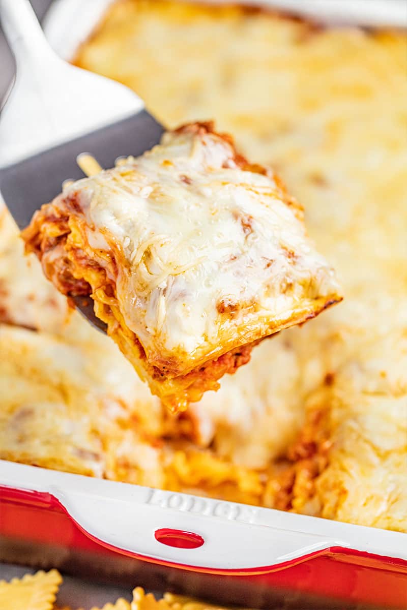 A piece of ravioli lasagna on a spatula ready to be served.