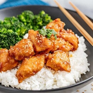General Tso Chicken on top of white rice and broccoli.
