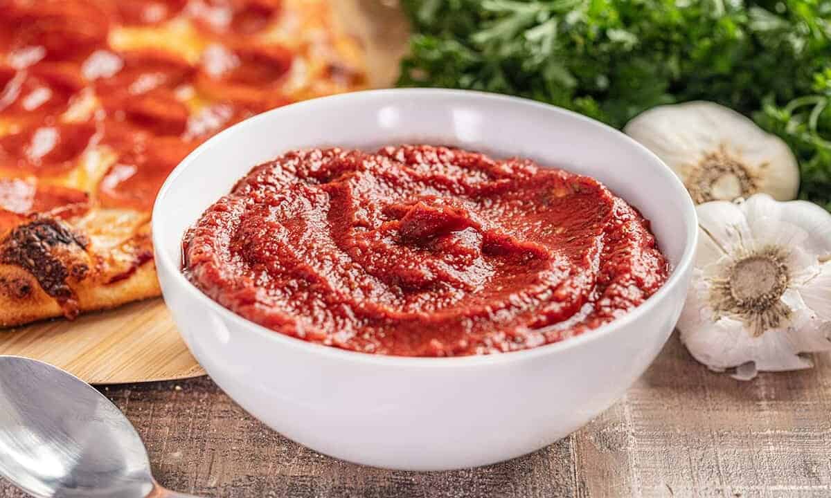 Homemade pizza sauce in a white bowl.