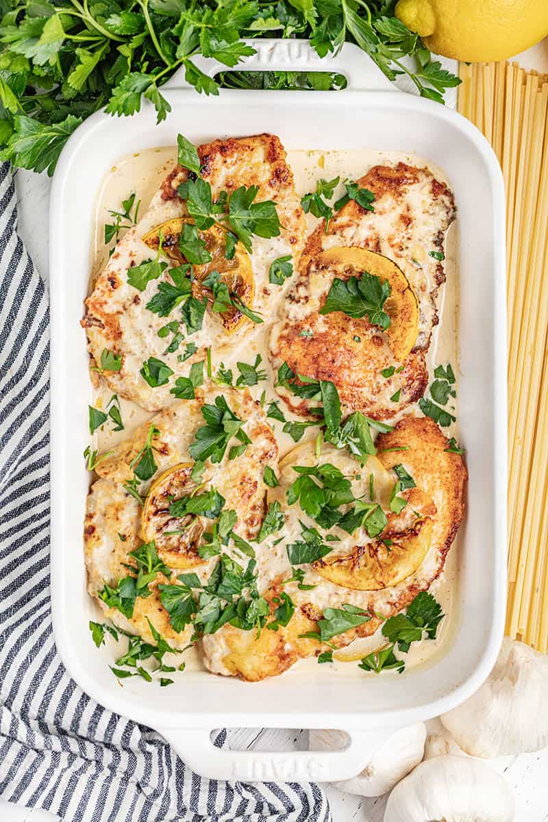 An overhead view of chicken francese in a baking dish.