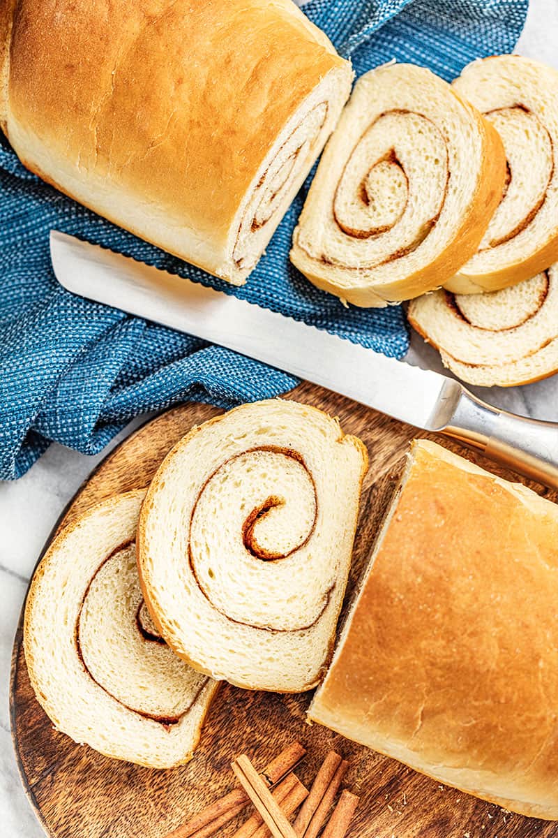 Overhead view of 2 cut loaves of cinnamon swirl bread.