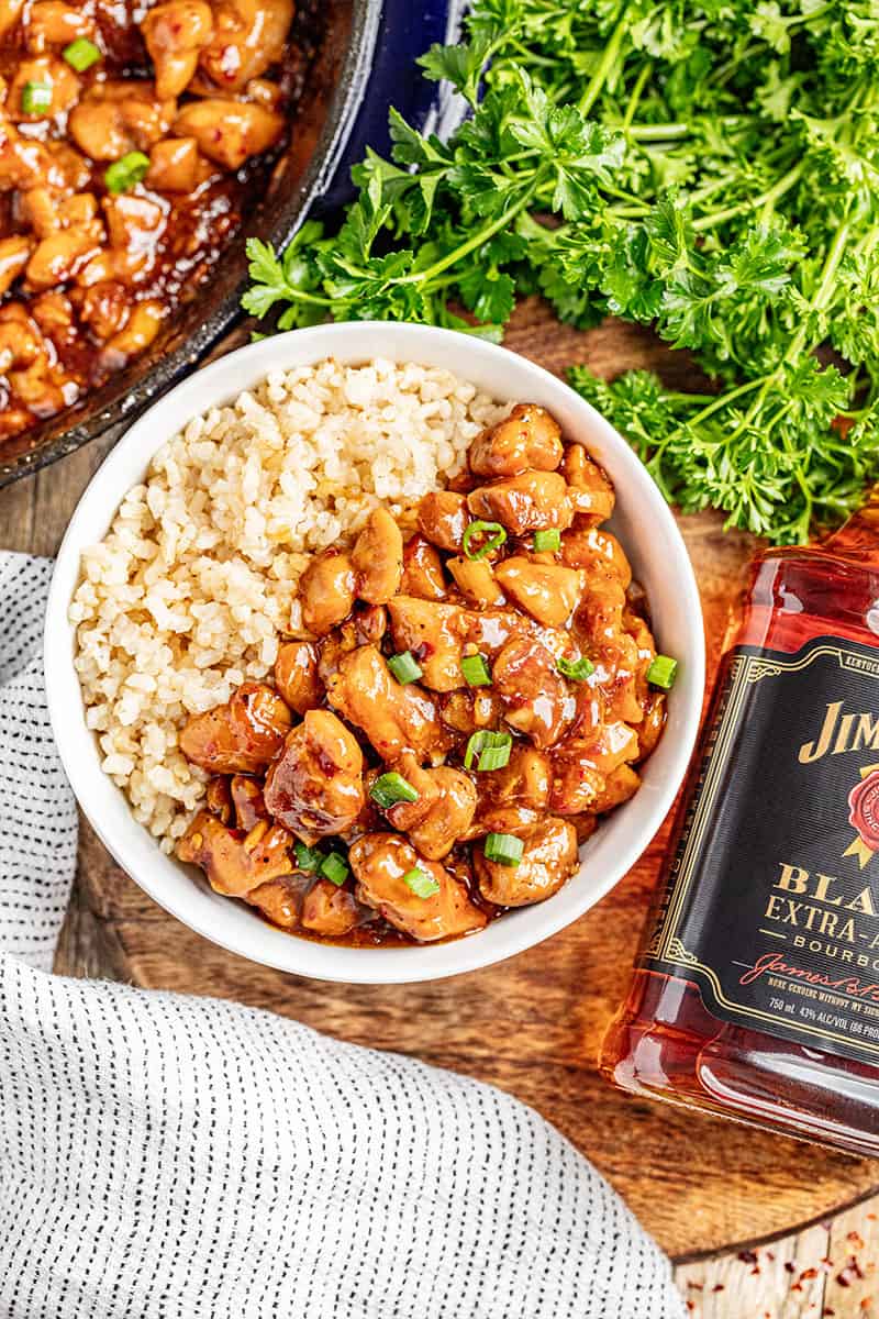 Saucy bourbon chicken and rice in a bowl.