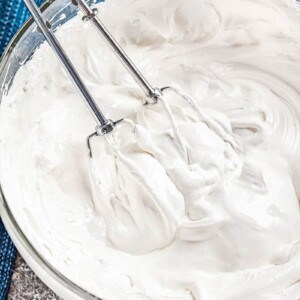 A bowl with beaters filled with 7 minute frosting.