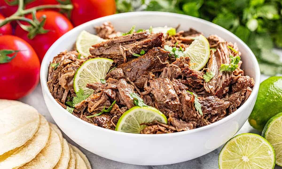A white bowl filled with Chili lime Mexican shredded beef.