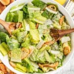 A large bowl of Caesar salad with croutons.