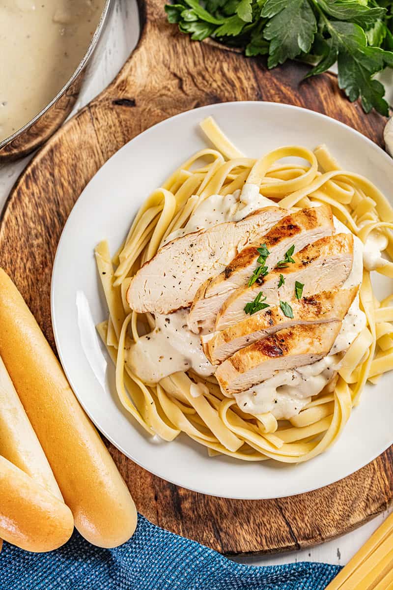 Classic chicken Alfredo with breadsticks.